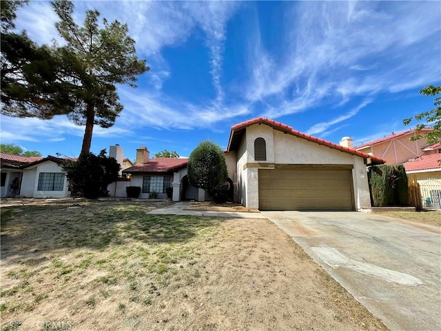 1305 Herzel Ave, Lancaster, CA 93535 - mediterranean / spanish-style home featuring stucco siding, a garage, concrete driveway, and a tile roof