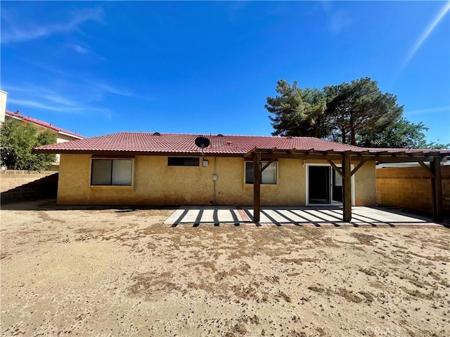 1305 Herzel Ave, Lancaster, CA 93535 - back of property featuring stucco siding, a patio area, and a tiled roof