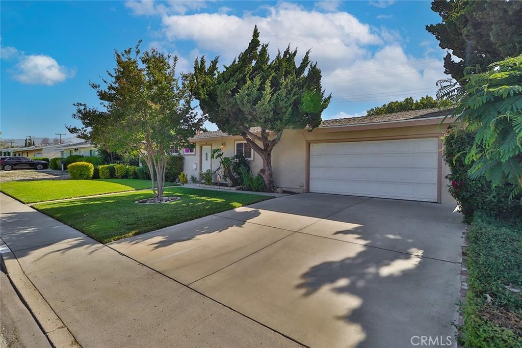 2212 Cordero Ave, Simi Valley, CA 93065 - view of front of house featuring driveway, an attached garage, a front yard, and stucco siding
