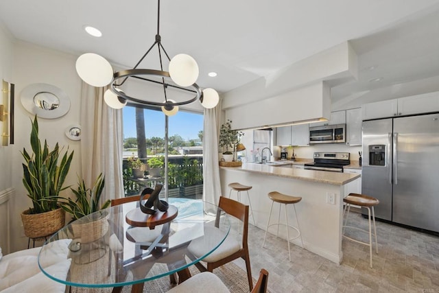 7930 Mission Center Ct Unit F, San Diego, CA 92108 - dining room with a chandelier, stone finish floors, and recessed lighting
