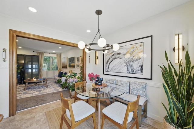 7930 Mission Center Ct Unit F, San Diego, CA 92108 - dining area featuring a chandelier, recessed lighting, crown molding, and a wainscoted wall