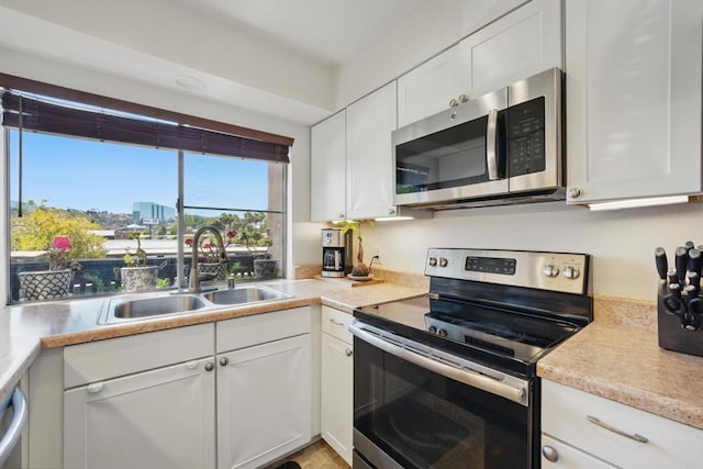7930 Mission Center Ct Unit F, San Diego, CA 92108 - kitchen featuring stainless steel appliances, a sink, white cabinetry, and light countertops
