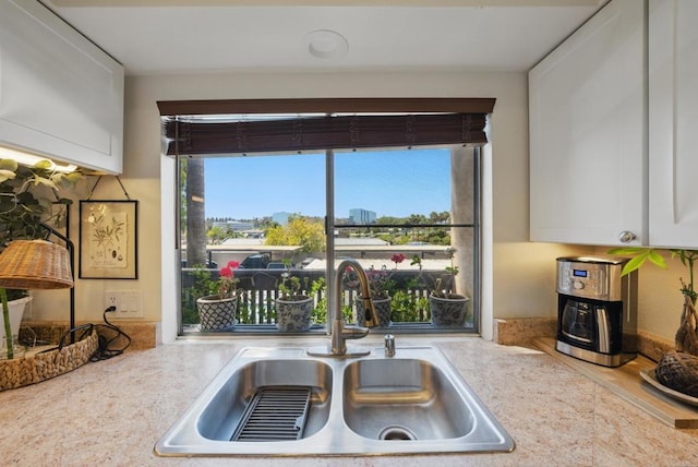 7930 Mission Center Ct Unit F, San Diego, CA 92108 - kitchen featuring a sink, light countertops, and white cabinetry