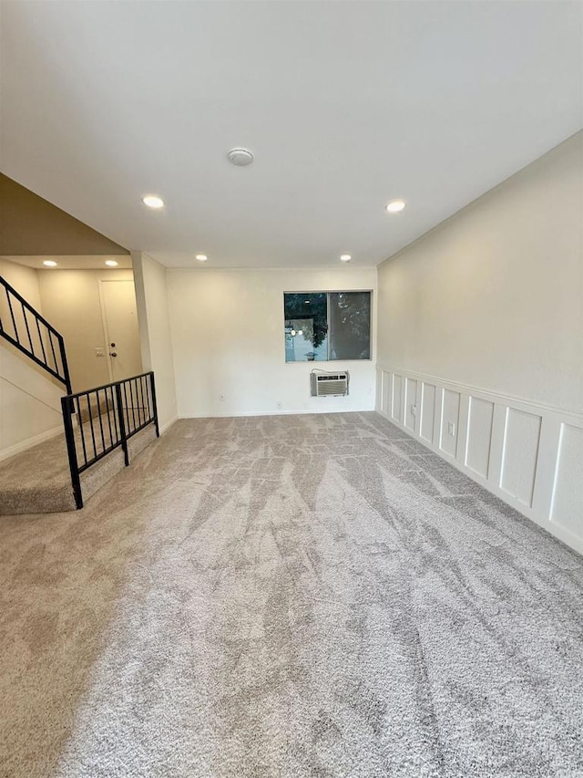 7930 Mission Center Ct Unit F, San Diego, CA 92108 - unfurnished living room featuring carpet flooring, a wall mounted air conditioner, recessed lighting, and stairway