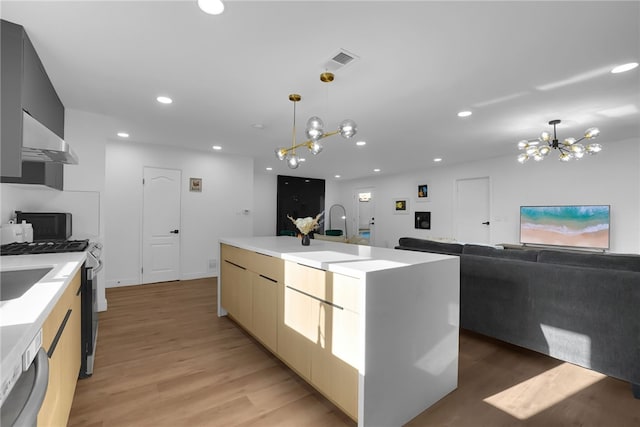 5548 Irondale Ave, Los Angeles, CA 91367 - kitchen featuring a chandelier, wall chimney exhaust hood, modern cabinets, recessed lighting, and hanging light fixtures