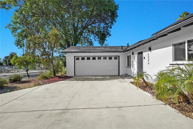 5548 Irondale Ave, Los Angeles, CA 91367 - view of property exterior featuring stucco siding, a garage, and driveway