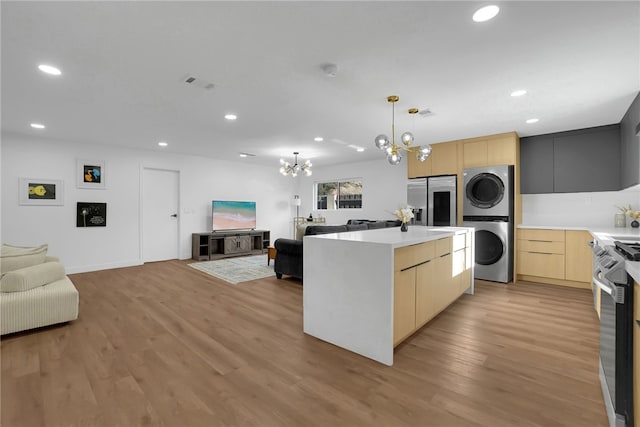 5548 Irondale Ave, Los Angeles, CA 91367 - kitchen with stacked washer / drying machine, stainless steel appliances, light brown cabinetry, open floor plan, and a chandelier