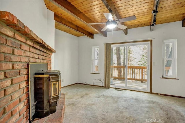 33079 Ridge Rd, Arrowbear, CA 92382 - unfurnished living room featuring a wood stove, wood ceiling with exposed beams, carpet, a ceiling fan, and baseboards