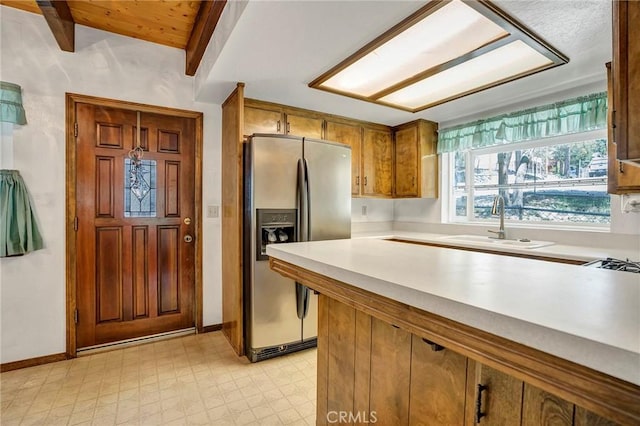 33079 Ridge Rd, Arrowbear, CA 92382 - kitchen with stainless steel fridge, a sink, light floors, brown cabinetry, and light countertops