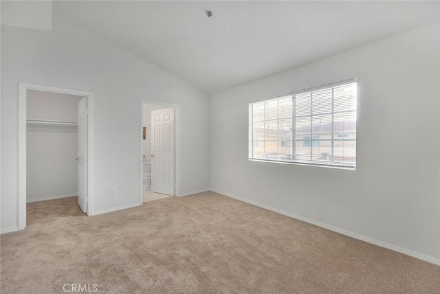 4315 W 145th St Unit 10, Lawndale, CA 90260 - unfurnished bedroom with a spacious closet, light carpet, lofted ceiling, baseboards, and a closet
