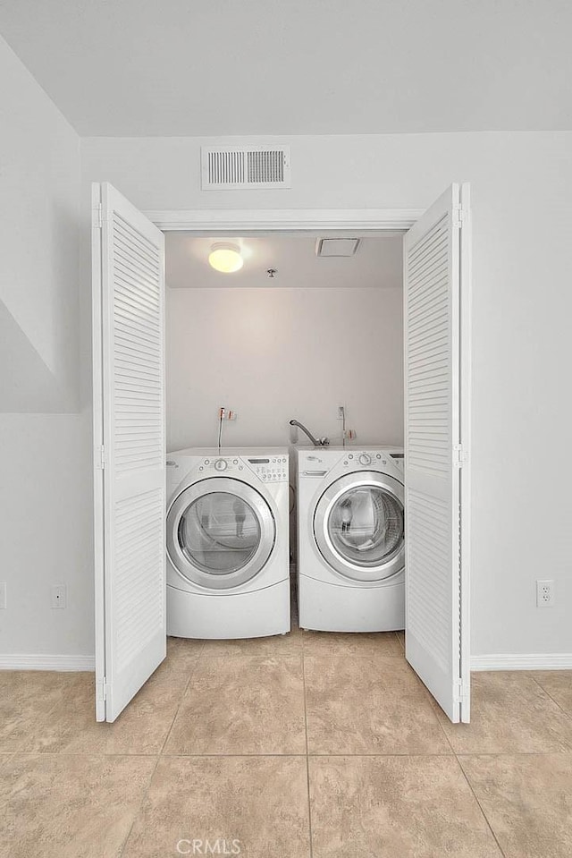 4315 W 145th St Unit 10, Lawndale, CA 90260 - washroom featuring independent washer and dryer, light tile patterned floors, and baseboards