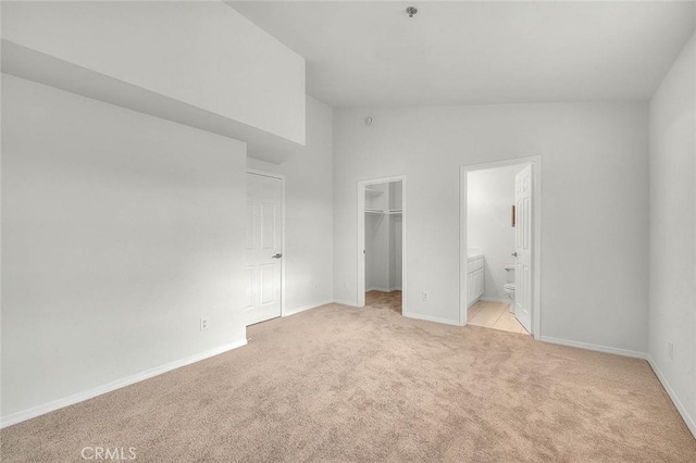 4315 W 145th St Unit 10, Lawndale, CA 90260 - unfurnished bedroom featuring light colored carpet, vaulted ceiling, a spacious closet, a closet, and baseboards