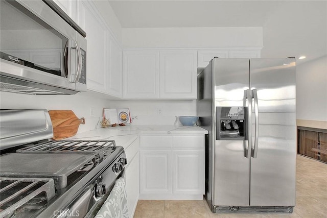 4315 W 145th St Unit 10, Lawndale, CA 90260 - kitchen featuring appliances with stainless steel finishes, white cabinets, light stone countertops, and light tile patterned flooring