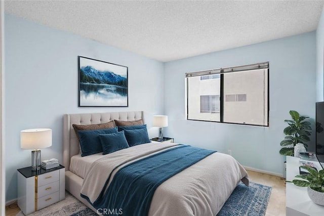 11952 Darlington Ave Unit 6, Los Angeles, CA 90049 - bedroom with a textured ceiling, baseboards, and light colored carpet
