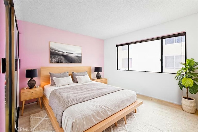 11952 Darlington Ave Unit 6, Los Angeles, CA 90049 - bedroom featuring a textured ceiling and light wood finished floors