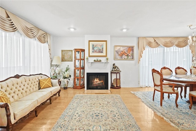 11952 Darlington Ave Unit 6, Los Angeles, CA 90049 - living area with a fireplace with flush hearth, wood finished floors, and a chandelier