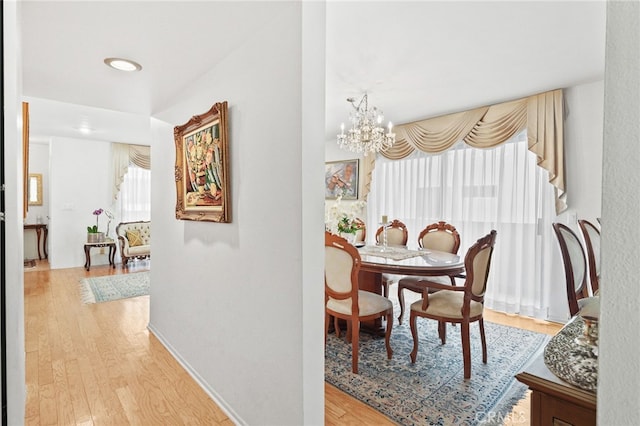 11952 Darlington Ave Unit 6, Los Angeles, CA 90049 - dining room with light wood-style floors, a chandelier, and recessed lighting