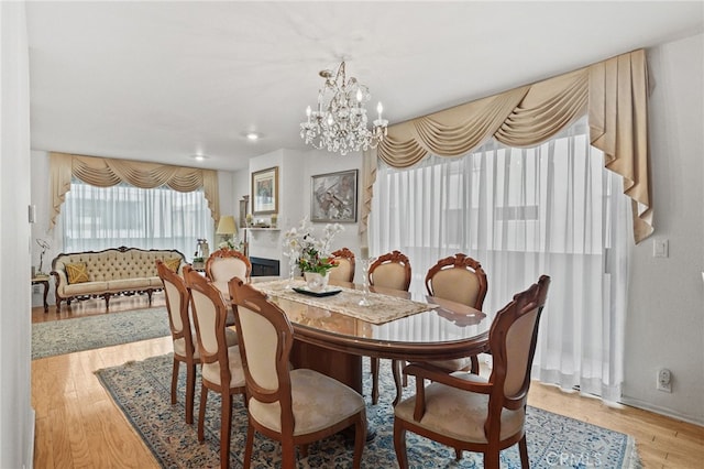 11952 Darlington Ave Unit 6, Los Angeles, CA 90049 - dining space with a chandelier, wood finished floors, recessed lighting, and baseboards