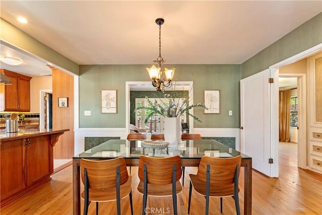 2042 E Crary St, Pasadena, CA 91104 - dining room featuring a chandelier, light wood finished floors, and healthy amount of natural light