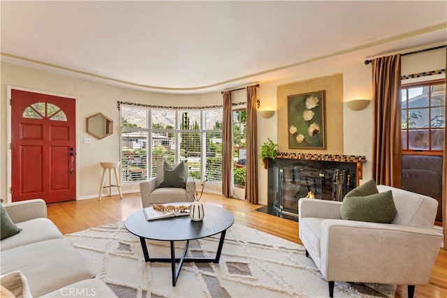 2042 E Crary St, Pasadena, CA 91104 - living area featuring a fireplace with flush hearth, healthy amount of natural light, wood finished floors, and baseboards