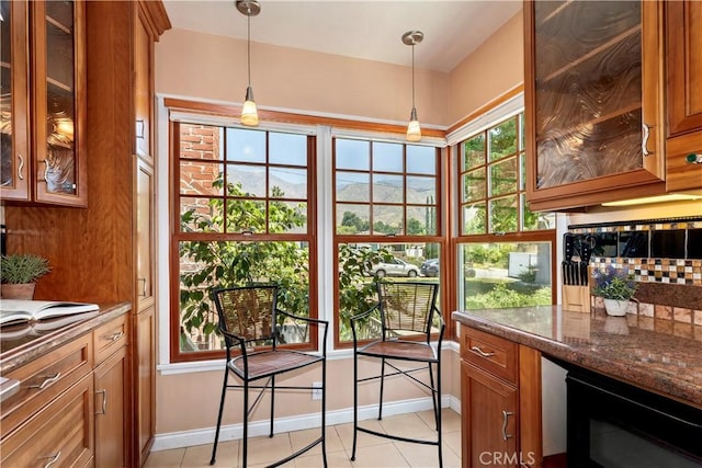 2042 E Crary St, Pasadena, CA 91104 - kitchen with brown cabinetry, baseboards, hanging light fixtures, light tile patterned flooring, and wine cooler