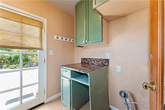 2042 E Crary St, Pasadena, CA 91104 - kitchen featuring green cabinets, dark stone counters, light tile patterned flooring, and baseboards