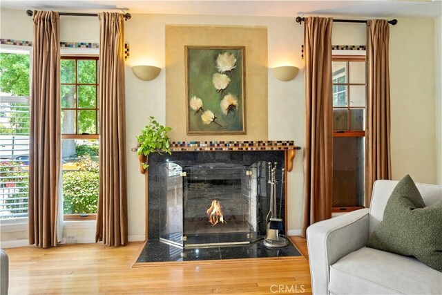 2042 E Crary St, Pasadena, CA 91104 - living area with wood finished floors, a fireplace with flush hearth, and baseboards