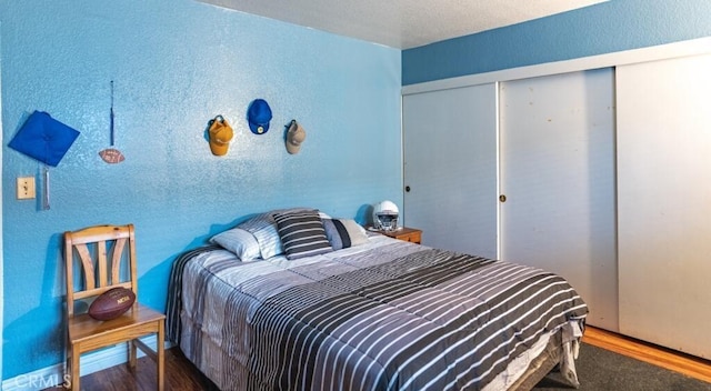 916 E 65th St Unit 3, Inglewood, CA 90302 - bedroom with a textured wall, a closet, and wood finished floors