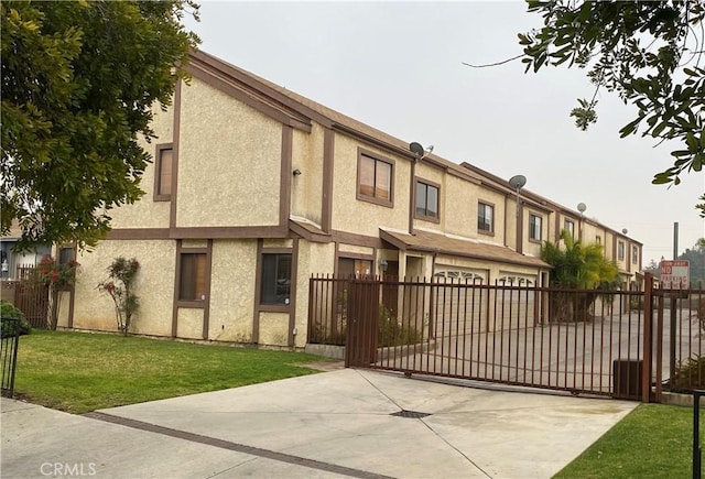 916 E 65th St Unit 3, Inglewood, CA 90302 - view of front of house featuring a gate, stucco siding, a garage, and driveway