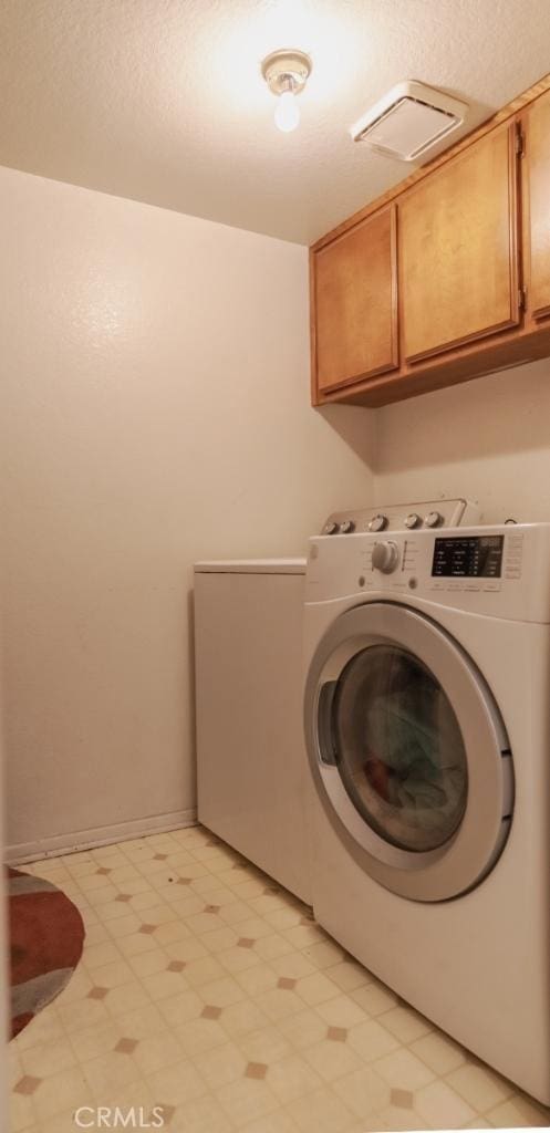 916 E 65th St Unit 3, Inglewood, CA 90302 - washroom featuring washer / clothes dryer, cabinet space, and light flooring
