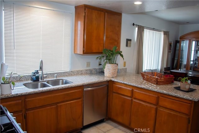 916 E 65th St Unit 3, Inglewood, CA 90302 - kitchen with dishwasher, brown cabinetry, a peninsula, and light tile patterned floors