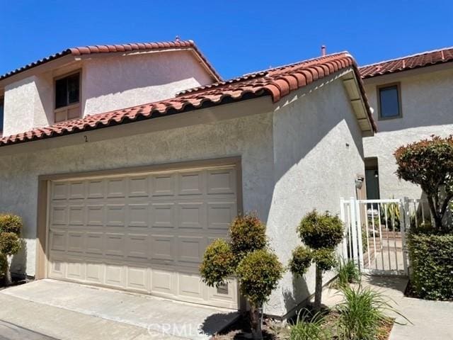 22809 Chardonnay Dr Unit 2, Diamond Bar, CA 91765 - view of home's exterior with stucco siding, a garage, and a tiled roof