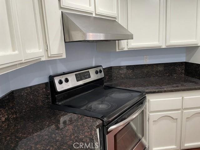 22809 Chardonnay Dr Unit 2, Diamond Bar, CA 91765 - kitchen featuring stainless steel electric stove, wall chimney exhaust hood, white cabinetry, and dark stone counters