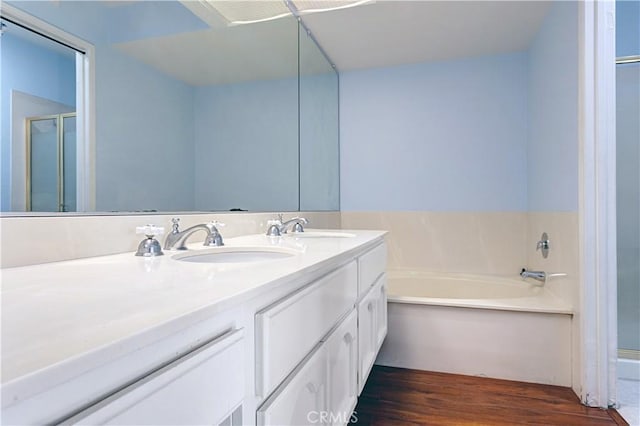 22809 Chardonnay Dr Unit 2, Diamond Bar, CA 91765 - bathroom with double vanity, a garden tub, wood finished floors, and an enclosed shower