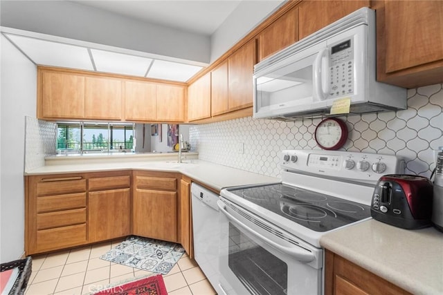 4505 California Ave Unit 506, Long Beach, CA 90807 - kitchen featuring white appliances, tasteful backsplash, light countertops, and a sink