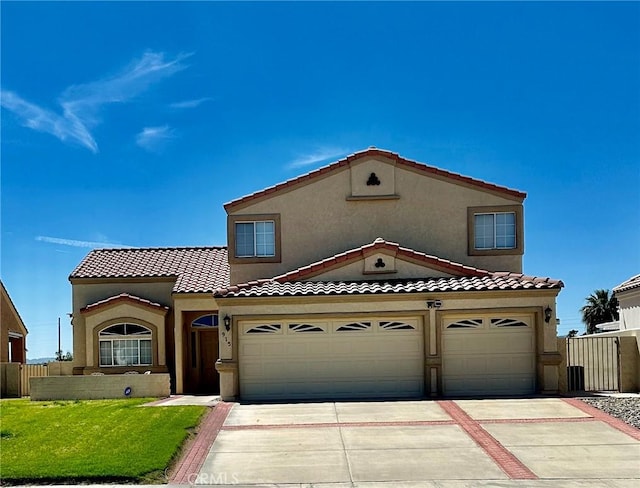 915 Beach Dr, Needles, CA 92363 - mediterranean / spanish home featuring driveway, stucco siding, and a tile roof