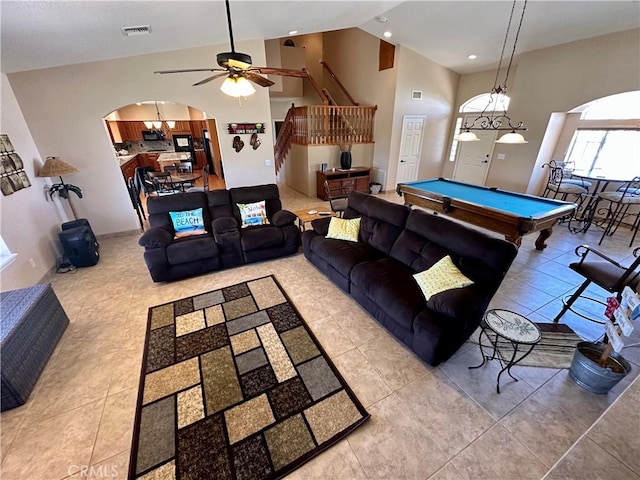 915 Beach Dr, Needles, CA 92363 - tiled living area with ceiling fan, arched walkways, stairway, pool table, and high vaulted ceiling