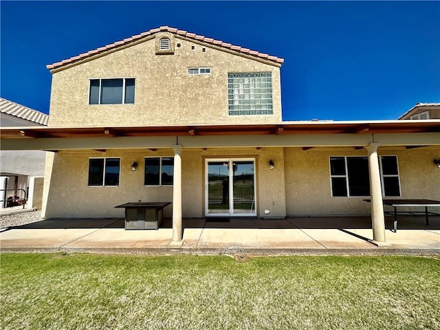 915 Beach Dr, Needles, CA 92363 - back of property featuring stucco siding, a patio, and a lawn