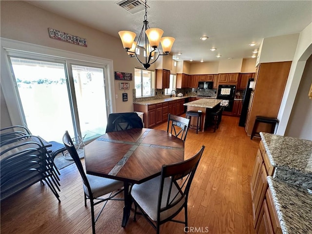 915 Beach Dr, Needles, CA 92363 - dining space with a chandelier, light wood-type flooring, and recessed lighting