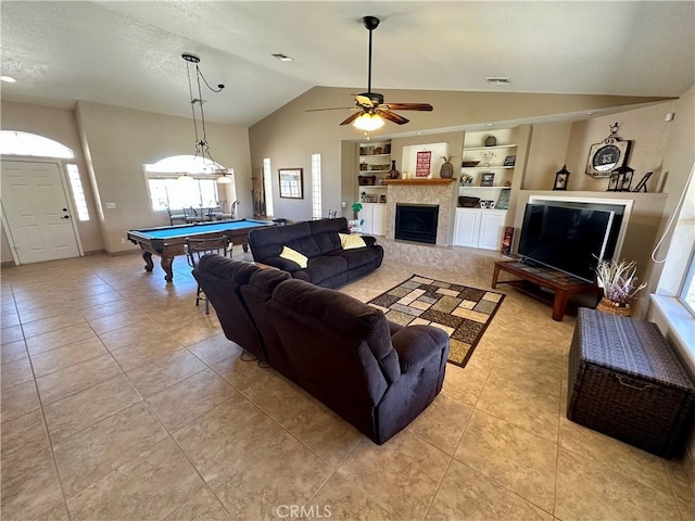 915 Beach Dr, Needles, CA 92363 - living area featuring lofted ceiling, plenty of natural light, built in shelves, and light tile patterned floors