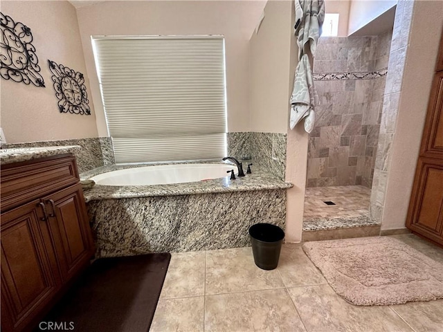 915 Beach Dr, Needles, CA 92363 - bathroom featuring a garden tub, a tile shower, tile patterned flooring, and vanity