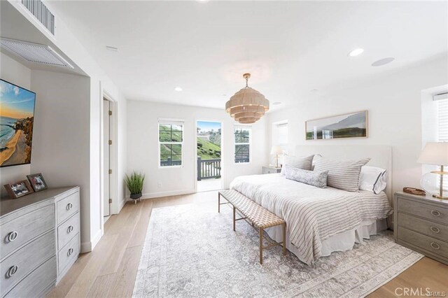32 Bargemon, Newport Coast, CA 92657 - bedroom with a chandelier, access to exterior, light wood-style floors, recessed lighting, and baseboards