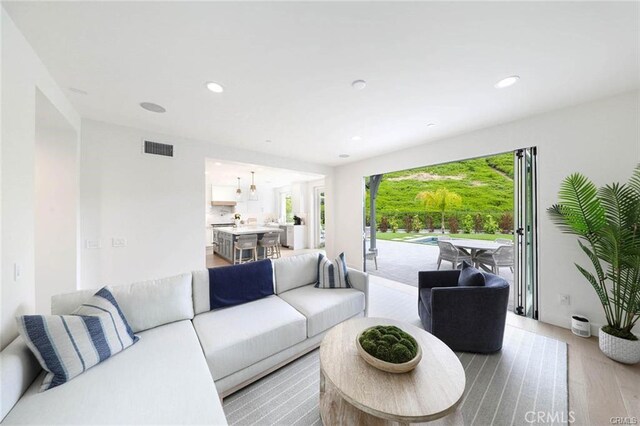 32 Bargemon, Newport Coast, CA 92657 - living room with light wood-style flooring and recessed lighting