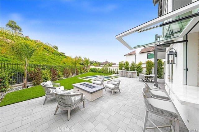 32 Bargemon, Newport Coast, CA 92657 - fenced backyard with a patio area and an outdoor living space with a fire pit