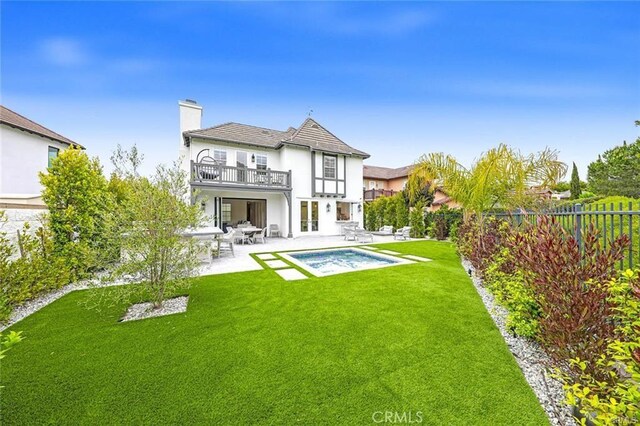 32 Bargemon, Newport Coast, CA 92657 - rear view of property featuring a balcony, a patio area, a chimney, and stucco siding