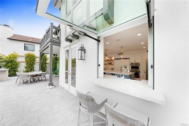 32 Bargemon, Newport Coast, CA 92657 - view of patio featuring french doors, outdoor dining area, and a sink
