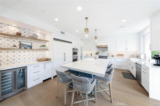 32 Bargemon, Newport Coast, CA 92657 - kitchen featuring wine cooler, stainless steel appliances, tasteful backsplash, a sink, and recessed lighting