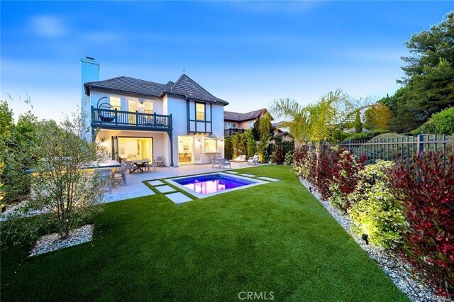 32 Bargemon, Newport Coast, CA 92657 - back of property featuring a balcony, a patio, stucco siding, and a chimney