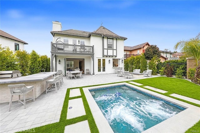 32 Bargemon, Newport Coast, CA 92657 - back of house featuring a balcony, a jacuzzi, french doors, a chimney, and a patio
