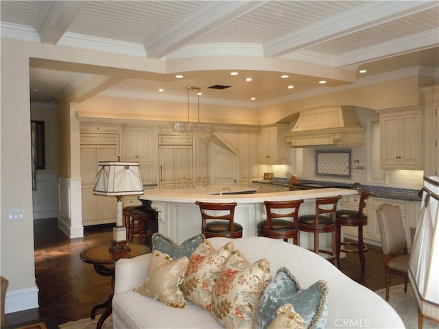 59 Rivo Alto Canal, Long Beach, CA 90803 - kitchen with a breakfast bar area, an island with sink, beamed ceiling, light countertops, and recessed lighting